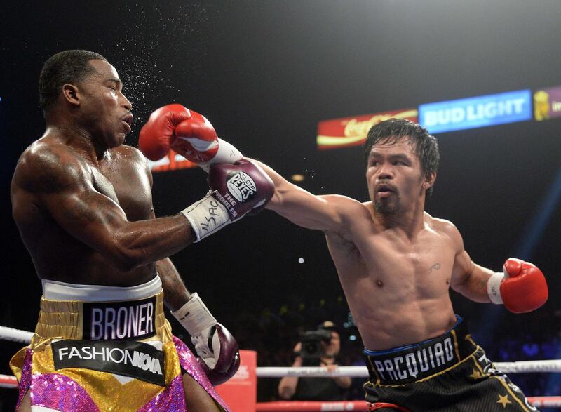 Jan 19, 2019; Las Vegas, NV, USA; Manny Pacquiao (black trunks) and Adrien Broner (purple/gold trunks) box during a WBA welterweight world title boxing match at MGM Grand Garden Arena. Pacquiao won via unanimous decision. Mandatory Credit: Joe Camporeale-USA TODAY Sports