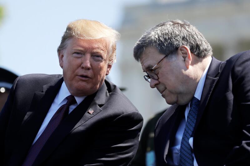 FILE - In this May 15, 2019, file photo, President Donald Trump and Attorney General William Barr speak at the 38th Annual National Peace Officers' Memorial Service at the U.S. Capitol in Washington. Trump is directing the U.S. intelligence community to "quickly and fully cooperate" with Barr's investigation of the origins of the multi-year probe into whether Trump's 2016 campaign colluded with Russia (AP Photo/Evan Vucci, File)