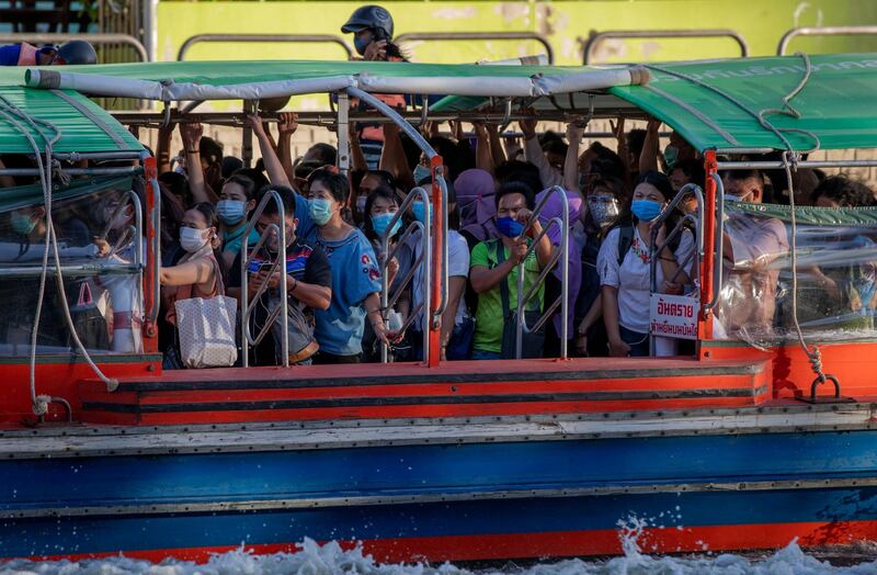 Passengers wearing face masks stand in close proximity as they ride a canal boat during the evening rush hour in Bangkok. AP Photo