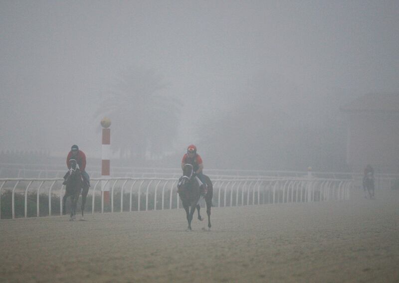 Dubai, United Arab Emirates, Jan 23 2013, Dubai stables Weather- Exercise  riders ride through the the early morning Fog as they workout their  horses. A thick fog blanketed the Dubai area for the second time in a row causing traffic to slow down because of the hazardous conditions. Mike Young / The National 
