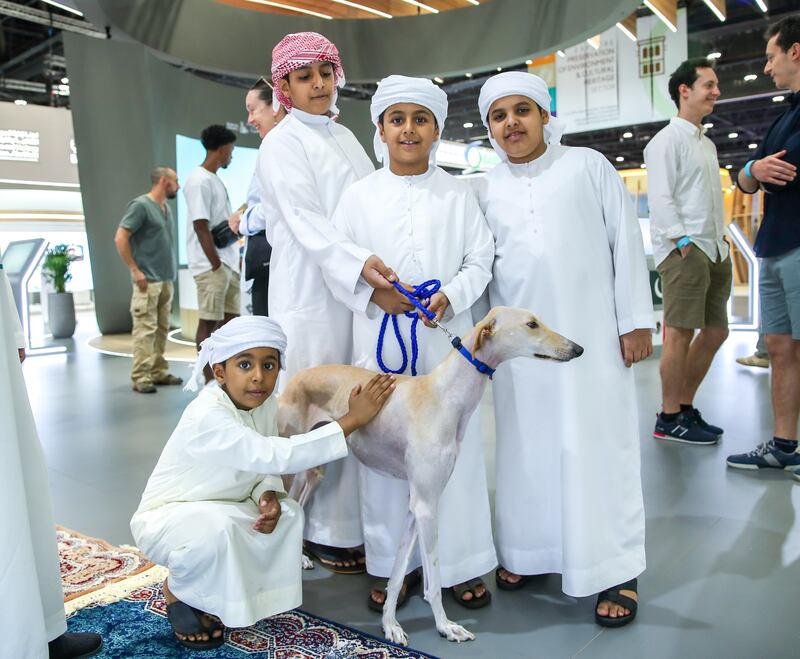 Children pose with a Saluki at Adihex. Victor Besa / The National