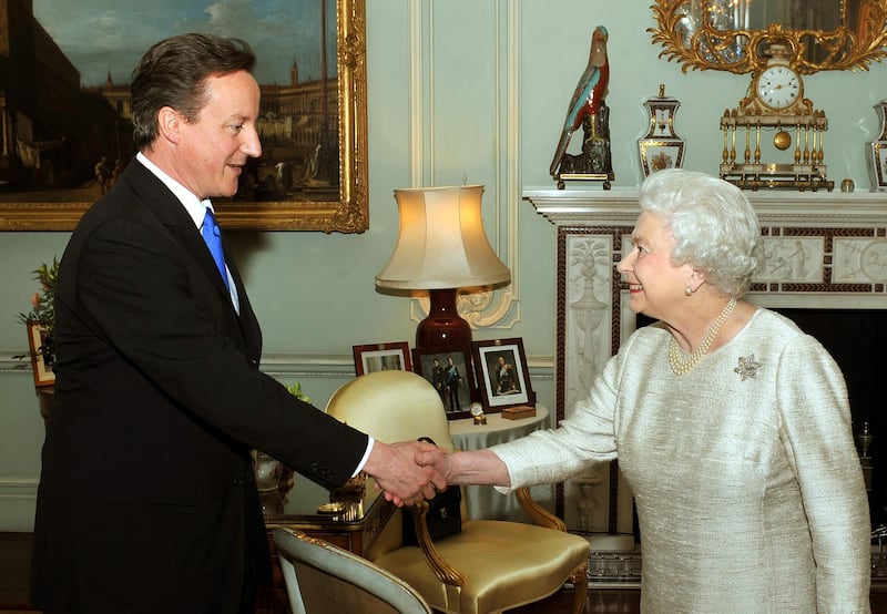 The queen and David Cameron shake hands at Buckingham Palace when he became prime minister in 2010. PA