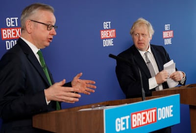 Britain's Prime Minister Boris Johnson listens to Michael Gove, who was chancellor of the Duchy of Lancaster at the time, in London in November 2019. Reuters