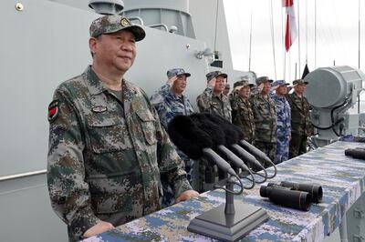 FILE - In this April 12, 2018, file photo released by Xinhua News Agency, Chinese President Xi Jinping, left, speaks after he reviewed the Chinese People's Liberation Army (PLA) Navy fleet in the South China Sea. From Asia to Africa, London to Berlin, Chinese envoys have set off diplomatic firestorms with a combative defense whenever their country is accused of not acting quickly enough to stem the spread of the coronavirus pandemic. (Li Gang/Xinhua via AP, File)