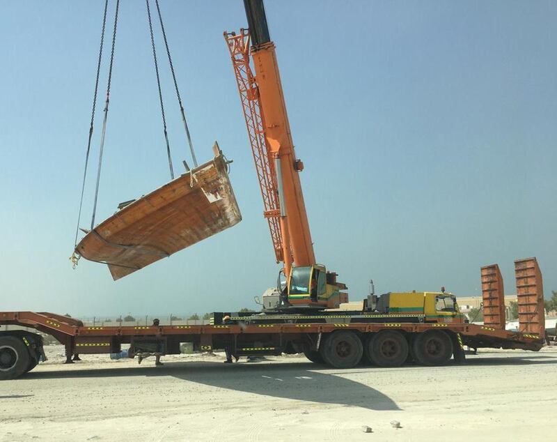 A boat is towed and impounded from the fisherman's port in Shahama. Courtesy Abu Dhabi Municipality