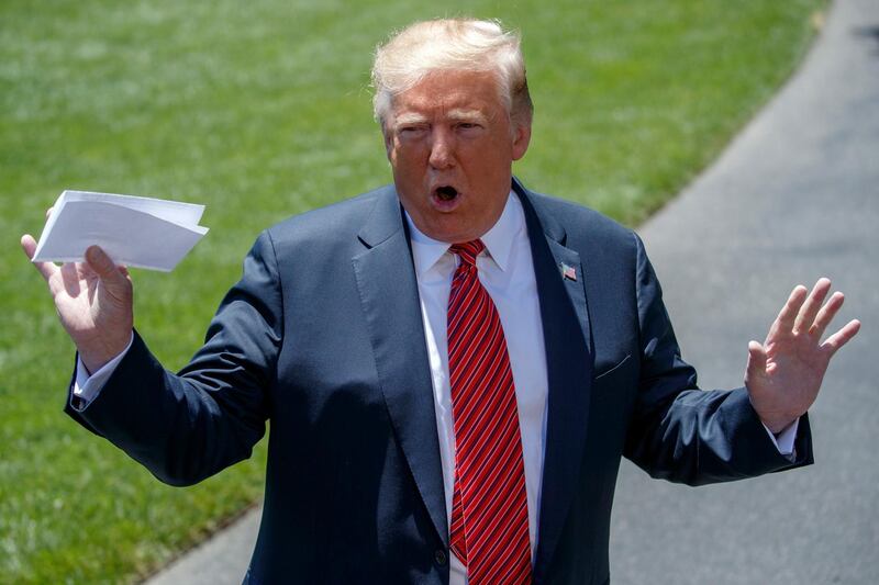 epa07649448 (FILE) - US President Donald J. Trump talks about a page from the United States-Mexico-Canada Agreement (USMCA) as he responds to a question from the news media on the South Lawn of the White House in Washington, DC, USA, 11 June 2019 (reissued 15 June 2019). Mexico has released a document that US President Donald Trump had previously presented to the press as a secret additional agreement to the migration agreement between the two countries. The agreement provides for the elaboration of another 'binding' bilateral agreement on the subject of migration. In principle, Mexico is to agree to the withdrawal of refugees from third countries who have arrived in the United States via its territory.  EPA/SHAWN THEW