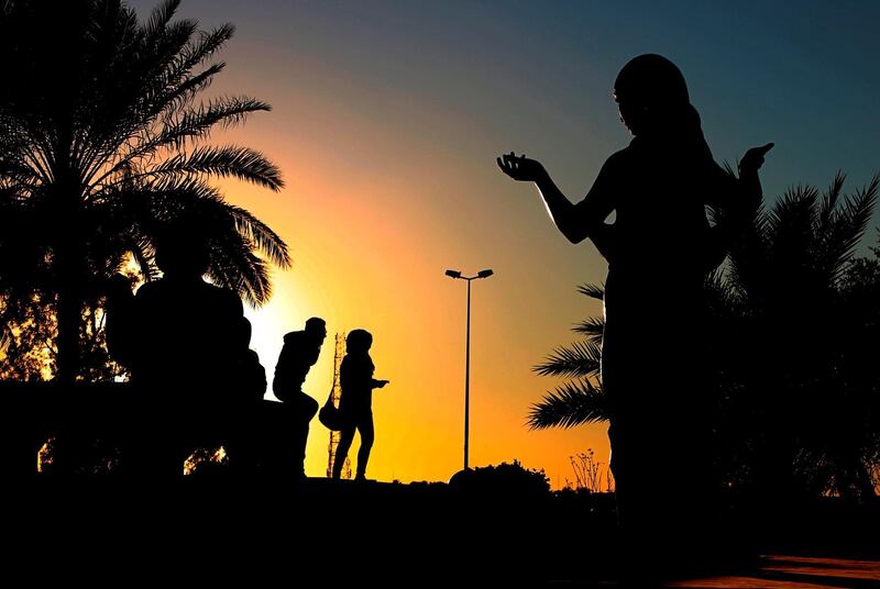 A couple walk along the banks of the Tigris near the statues of Prince Shahrazad and King Shahriar in Baghdad, Iraq. AP