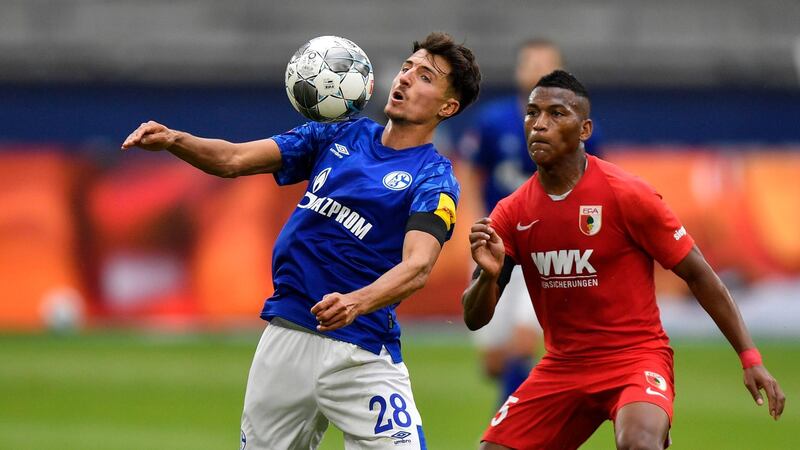 Schalke's Alessandro Schoepf and Augsburg's Carlos Gruezo, right, challenge for the ball. EPA