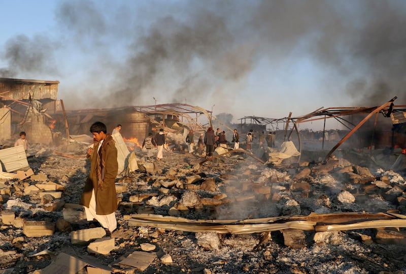 FILE PHOTO: Smoke rises as people inspect damage at the site of air strikes in the city of Saada, Yemen January 6, 2018. REUTERS/Naif Rahma/File Photo