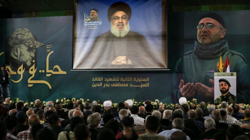 epa06736656 Supporters of Hezbollah watch Secretary General of Hezbollah Hassan Nasrallah on a big screen as he delivers his speech from an undisclosed location, during the celebration of the Second anniversary of the assassination of Hezbollah Jihadist Leader  'Sayed Mustafa Amin Badr Al-Din', in the southern suburb of Beirut, Lebanon, 14 May 2018. Badr al-Din, who was considered Hezbollah's most senior military commander, was killed in an attack in Syria in 2016. Nasrallah spoke about the situations in Palestine, Lebanon, Syria, and other Arab countries.  EPA/NABIL MOUNZER