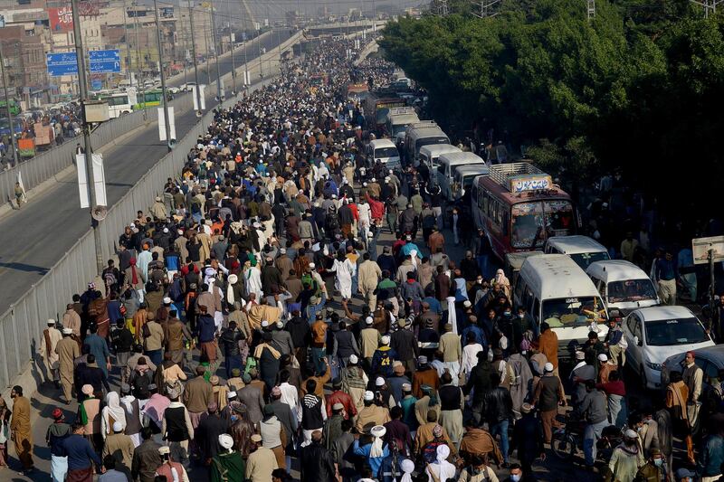 Mourners walk toward a ground to attend the funeral prayer of Khadim Hussein Rizvi, an Islamist scholar and leader of Tehreek-e-Labiak Pakistan, in Lahore, Pakistan.  AP