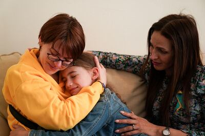 Ukrainian woman Kristina Korniiuk hugs Samantha Platings after being welcomed to the family home by Rend Platings, right. PA