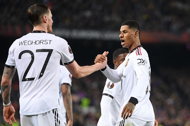 Manchester United's Marcus Rashford celebrates with Wout Weghorst after scoring his side's first goal in the Europa League first-leg clash with Barcelona on February 16, 2023. AFP