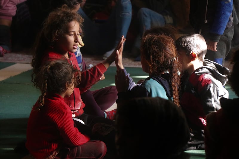 Displaced children play games in the mosque. EPA