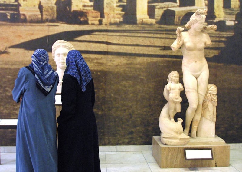 A file picture from March 5, 2002 shows Libyan women looking at Roman statues unearthed at the ancient city of Sabartha, some 67 kms west of Tripoli on display at the Saray Al Hamra, or Red House museum in the Libyan capital. Behrouz Mehri/AFP Photo