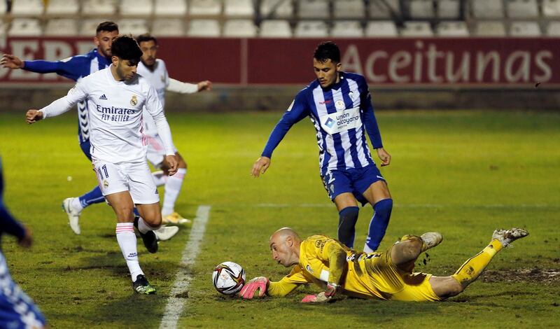 Alcoyano goalkeeper Jose Juan Figueiras saves a ball against Marco Asensio. EPA