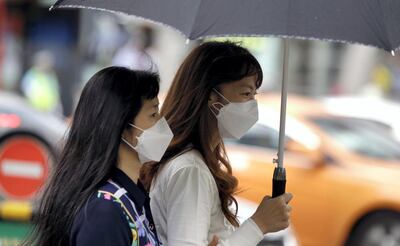 Tourists wear masks as a precaution against MERS (Middle East Respiratory Syndrome) at a shopping district in Seoul, South Korea, Friday, June 5, 2015. Sales of surgical masks surge amid fears of a deadly, poorly understood virus. Despite media warnings about the virus "spreading" in South Korea, most of the cases are linked to a single hospital, as is a Korean man diagnosed in China. There's no evidence yet in South Korea "of sustained transmission in the community," the WHO reports. (AP Photo/Lee Jin-man)