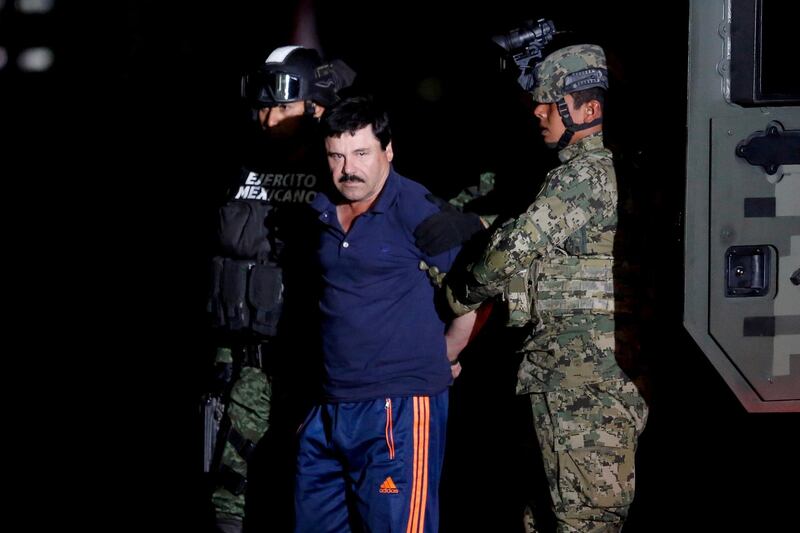 FILE PHOTO: Joaquin "El Chapo" Guzman is escorted by soldiers during a presentation in Mexico City, Jan. 8, 2016. REUTERS/Tomas Bravo/File Photo/File Photo