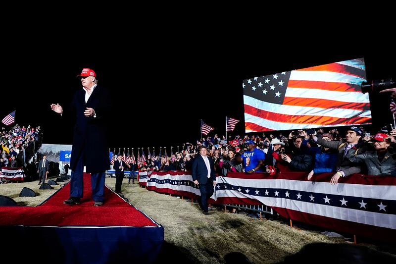 The former president whips up the large crowd in Arizona before making his speech. AP