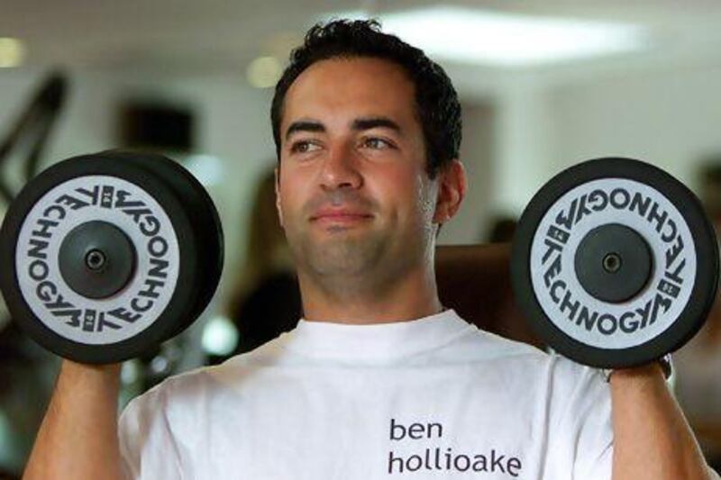 England cricketer Adam Hollioake, shown here lifting weights in 2003, will make his return to the UAE this weekend for a good cause. Matt Dunham / Reuters