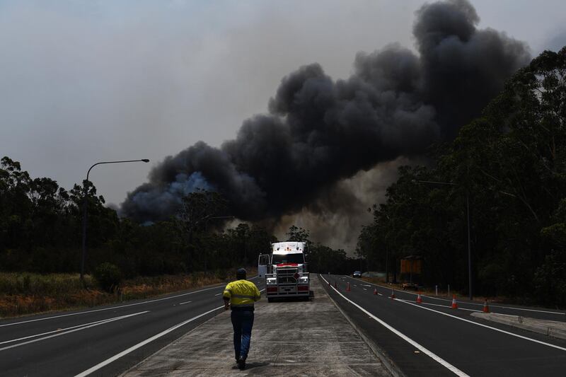 A truck driver prepares to move his vehicle through a roadblock bypass on the Princes Highway near the town of Sussex Inlet. Getty