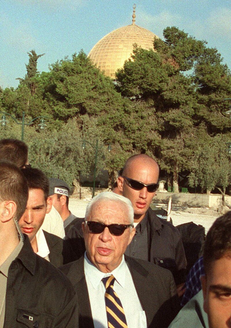 Israeli right-wing opposition leader Ariel Sharon flanked by security guards on a visit to Al Aqsa mosque compound in September 2000. AFP
