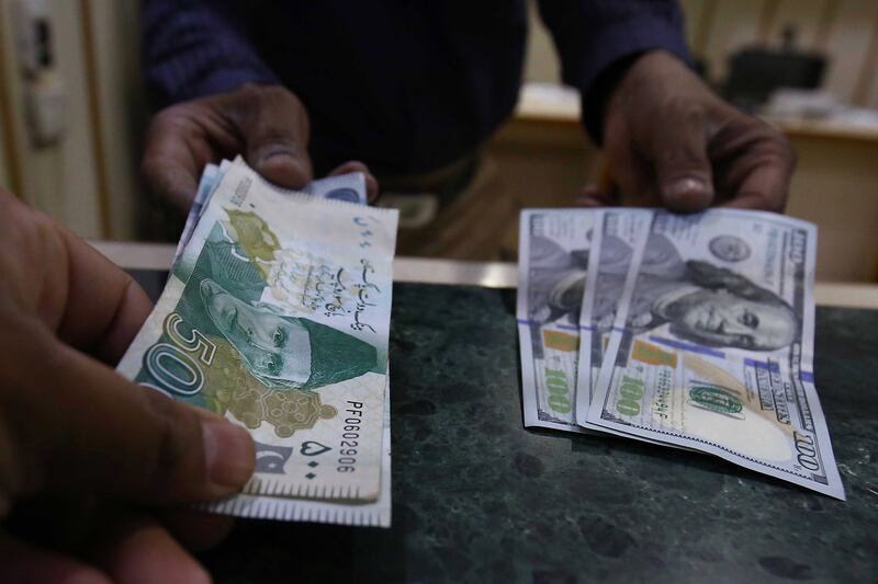 Pakistani rupee and US dollar banknotes at currency exchange in Karachi. The rupee touched a historic low in May. EPA