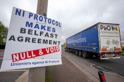 A lorry passes a sign with an anti-Protocol message near the port of Larne, north of Belfast, Northern Ireland. AFP