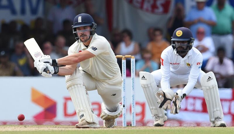 England's Rory Burns (L) plays a shot as Sri Lanka's wicketkeeper Niroshan Dickwella (R) looks on during the third day of the opening Test match between Sri Lanka and England at the Galle International Cricket Stadium in Galle on November 8, 2018. / AFP / ISHARA S. KODIKARA

