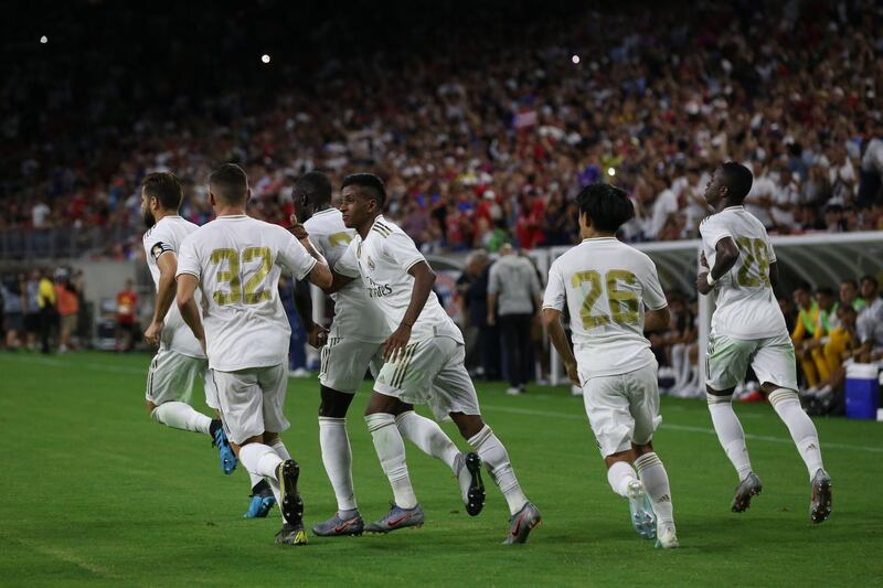 Real Madrid forward Rodrygo, centre, celebrates his consolation goal. Reuters
