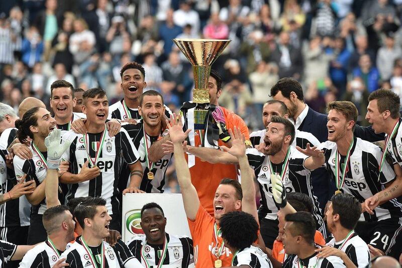 Juventus players celebrate with the trophy after the Serie A match against Sampdoria at Juventus Arena on May 14, 2016 in Turin, Italy. Valerio Pennicino/Getty Images