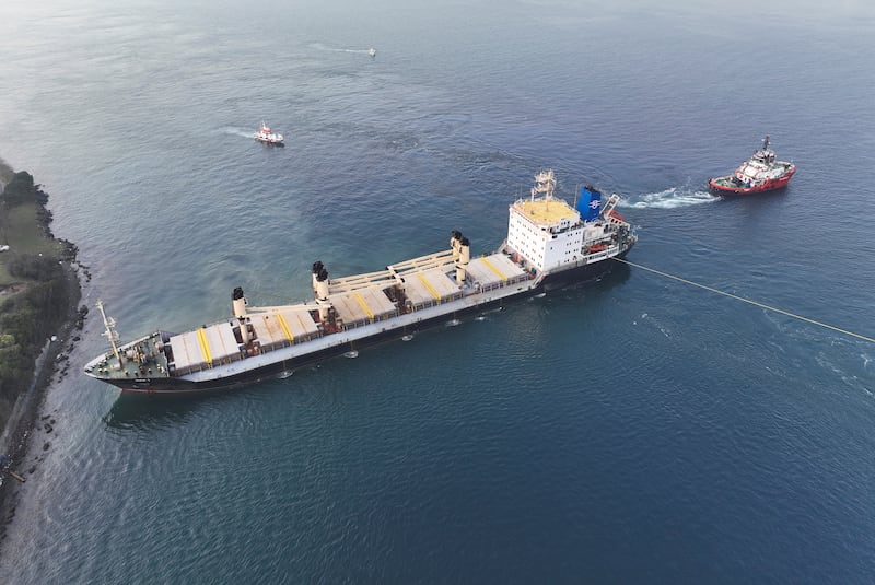 The Palau-flagged bulk carrier MKK1 is towed free after running aground. Reuters