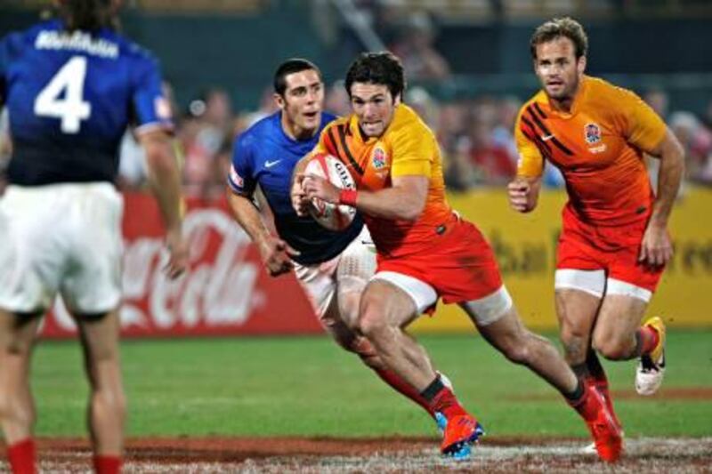 Dubai December 3, 2011 - England's Mat Turner runs up field against France in the finals of the Emirates Airlines Dubai Rugby Sevens tournament at the Rugby Sevens stadium in Dubai, December 3, 2011. Turner scored two tries as England defeated France 29-12. Turner was named Star of the Tournament. (Photo by Jeff Topping/The National)
