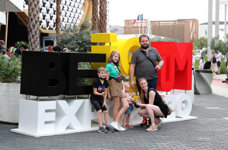Visitors pose for photos outside the closed Belgium pavilion.