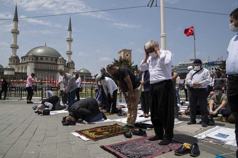 People pray at the Friday prayer in front of the newly built Taksim Mosque at the Taksim Square, during the opening ceremony of the mosque. EPA