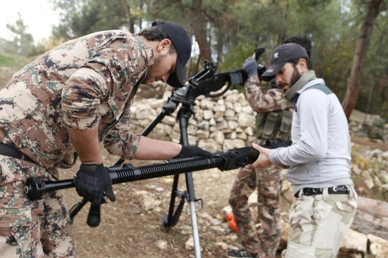 Rebel fighters prepare to fire a machine gun towards forces of Syria's president Bashar Al Assad in Syria's northwestern Latakia province. Alaa Khweled/Reuters