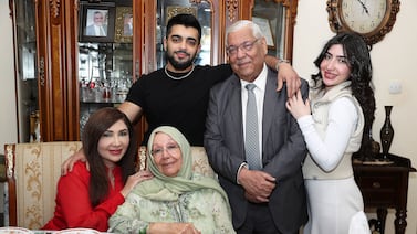 Saeed Nouri Al Tareefi with his wife, children and grandchildren at his home in Ajman. Pawan Singh / The National