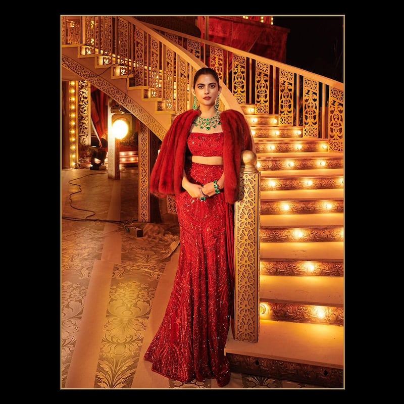Isha Ambani also wore red in a lehenga-inspired gown, which she paired with a giant emerald necklace as well as matching bracelet and earrings, and finished her look with a red fur jacket. Photo: @manishmalhotra05 / Instagram