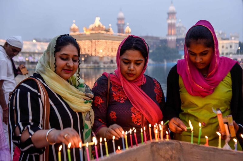 Sikh devotees light candles on the occasion of the 550th birth anniversary of Guru Nanak Dev at Sikh Golden Temple in Amritsar on November 12, 2019. AFP