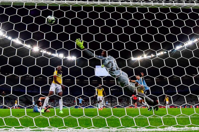 Uruguay's Luis Suarez (R) celebrates after an own goal by Ecuador's Arturo Mina (covered) during their Copa America football tournament group match at the Mineirao Stadium in Belo Horizonte, Brazil.  AFP