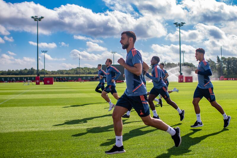 Bruno Fernandes, Tyrell Malacia and Jadon Sancho during Manchester United's training session in Carrington. Getty