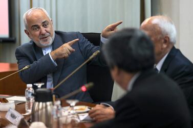 Iranian Foreign Minister Mohammad Javad Zarif, left, gestures as he speaks during a forum titled "Common Security in the Islamic World" in Kuala Lumpur, Malaysia. AP