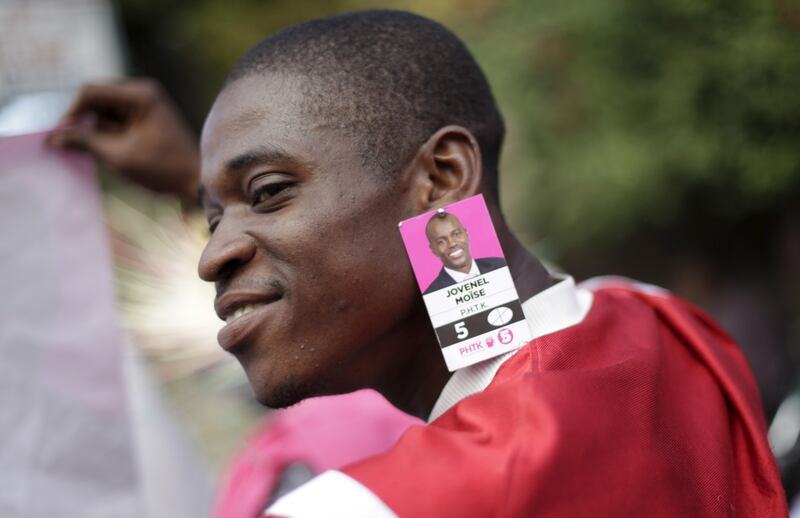 A supporter of Jovenel Moise in Port-au-Prince in 2016. Mr Moise was running for president at the time.