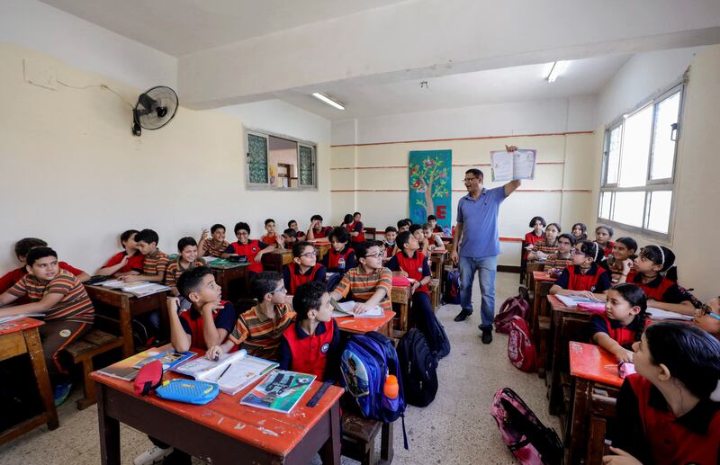 A teacher conducts a lesson in a classroom at Martyr Rami school, Cairo. Reuters