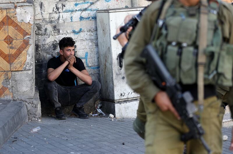 A Palestinian youth is detained by Israeli soldiers during clashes with Palestinian protesters in the occupied West Bank City of Hebron.  EPA
