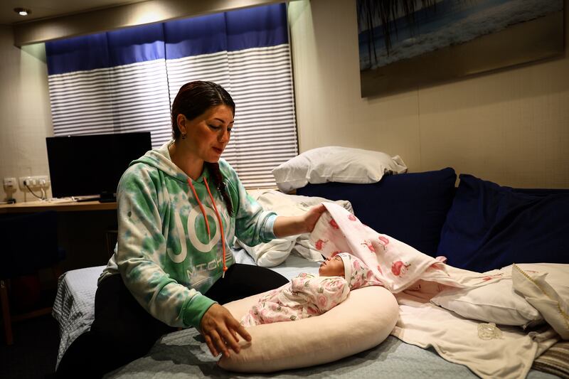 Survivor Gul Seker with her baby Miray on the cruise ship