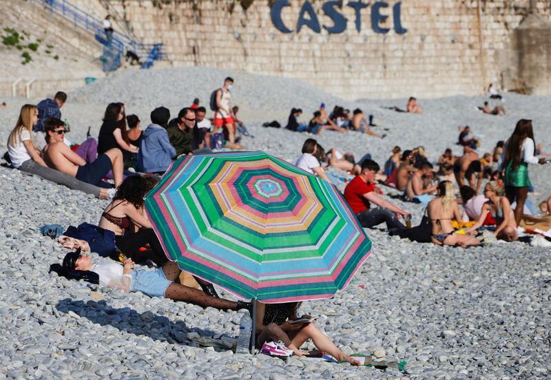 People enjoy sunny and warm weather on the beach of the Promenade des Anglais in Nice. Reuters