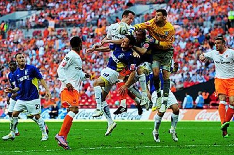 David Marshall, the Cardiff goalkeeper, tries to punch the ball away to safety against Blackpool at Wembley yesterday.