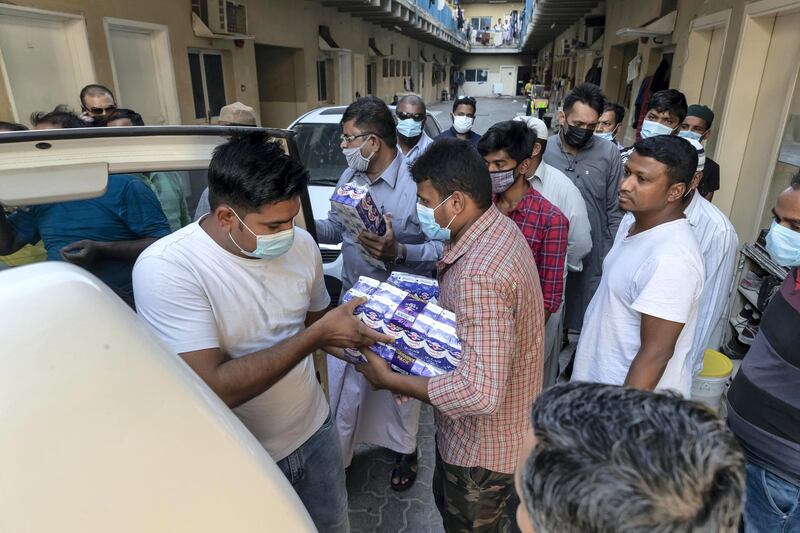 The Sri Lanka community distributes three hundred / 300 meals to workers at the Fakhruddin Camp in Sonapur, Dubai with the help of the to Al Watani volunteers and the CDA on April 23 rd, 2021. 
Antonie Robertson / The National.
Reporter: Ramola Talwar for National