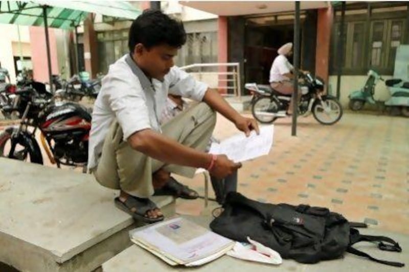 Vijay Kumar with his certificates outside an employment exchange office in New Delhi. While millions of job seekers have impressive sounding diplomas, many don’t have the skills promised from colleges and other institutes with poor standards.